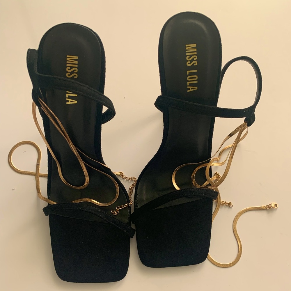 Black velvet strap heels with gold chain that wraps around the ankle.